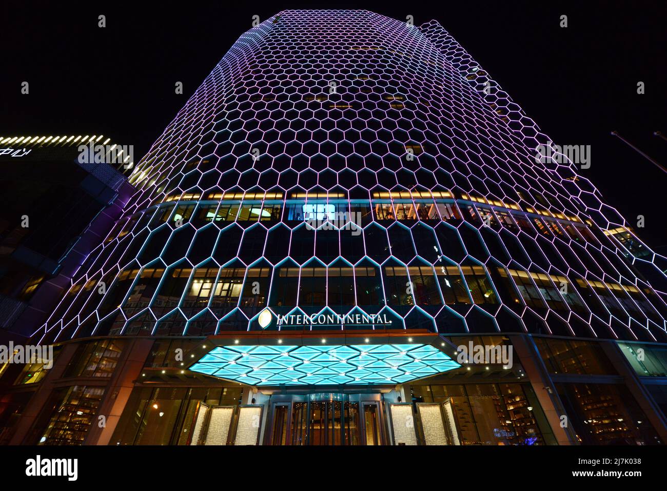 The Intercontinental Sanlitun Tongying Center hotel illuminated at night. Stock Photo