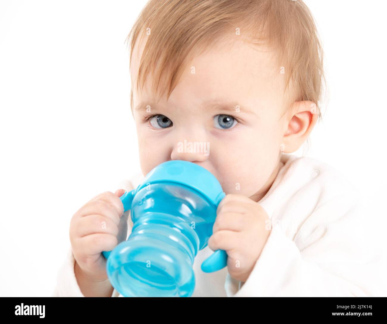 Stock studio photo with a white background of a baby drinking water