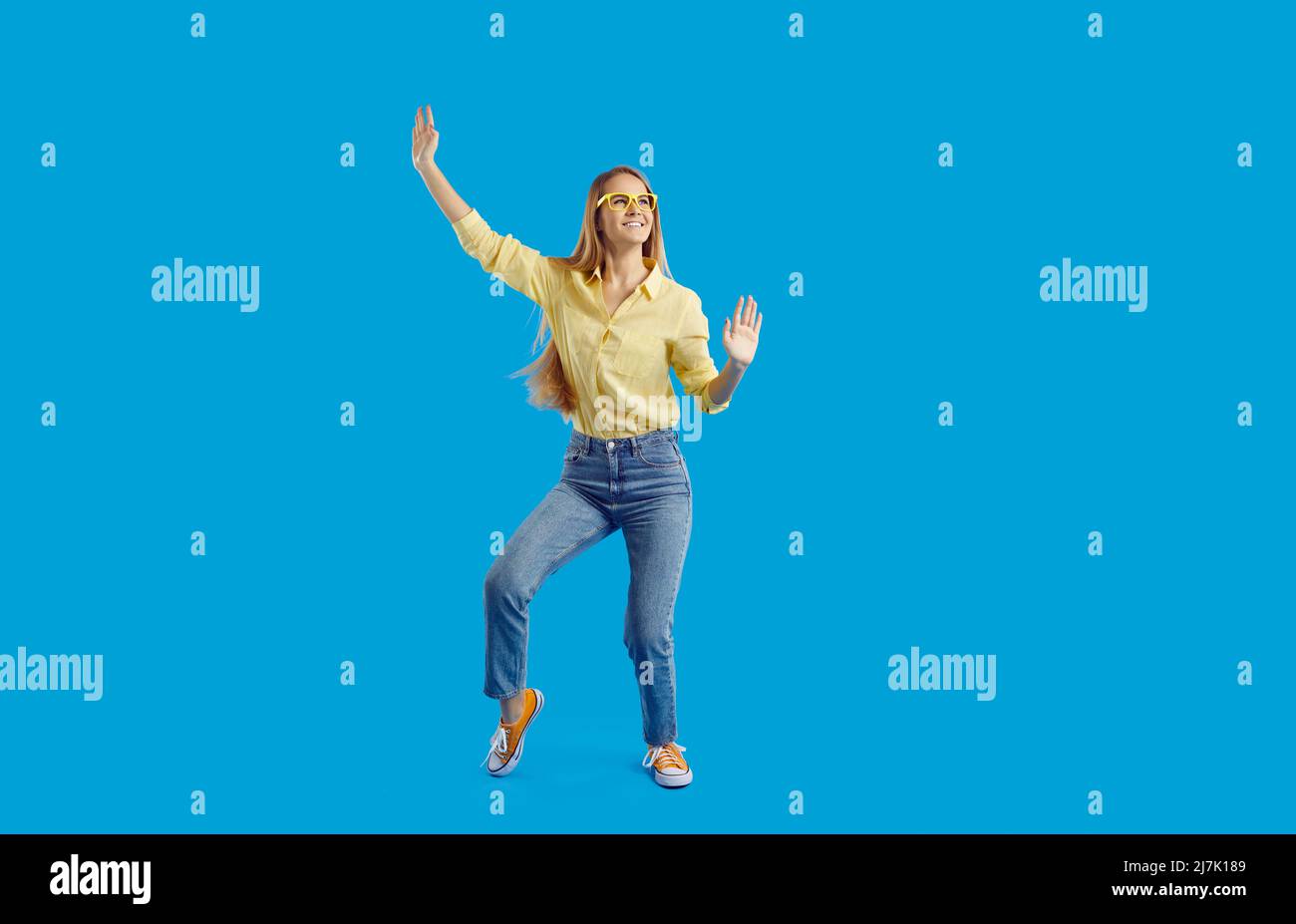 Smiling woman in casual wear enjoy dancing Stock Photo