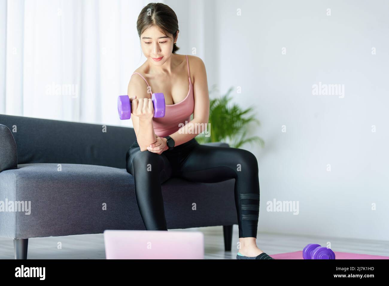 stress relief, , breathing exercises, meditation, portrait of Asian healthy woman lifting weights to strengthen her muscles after work. Stock Photo