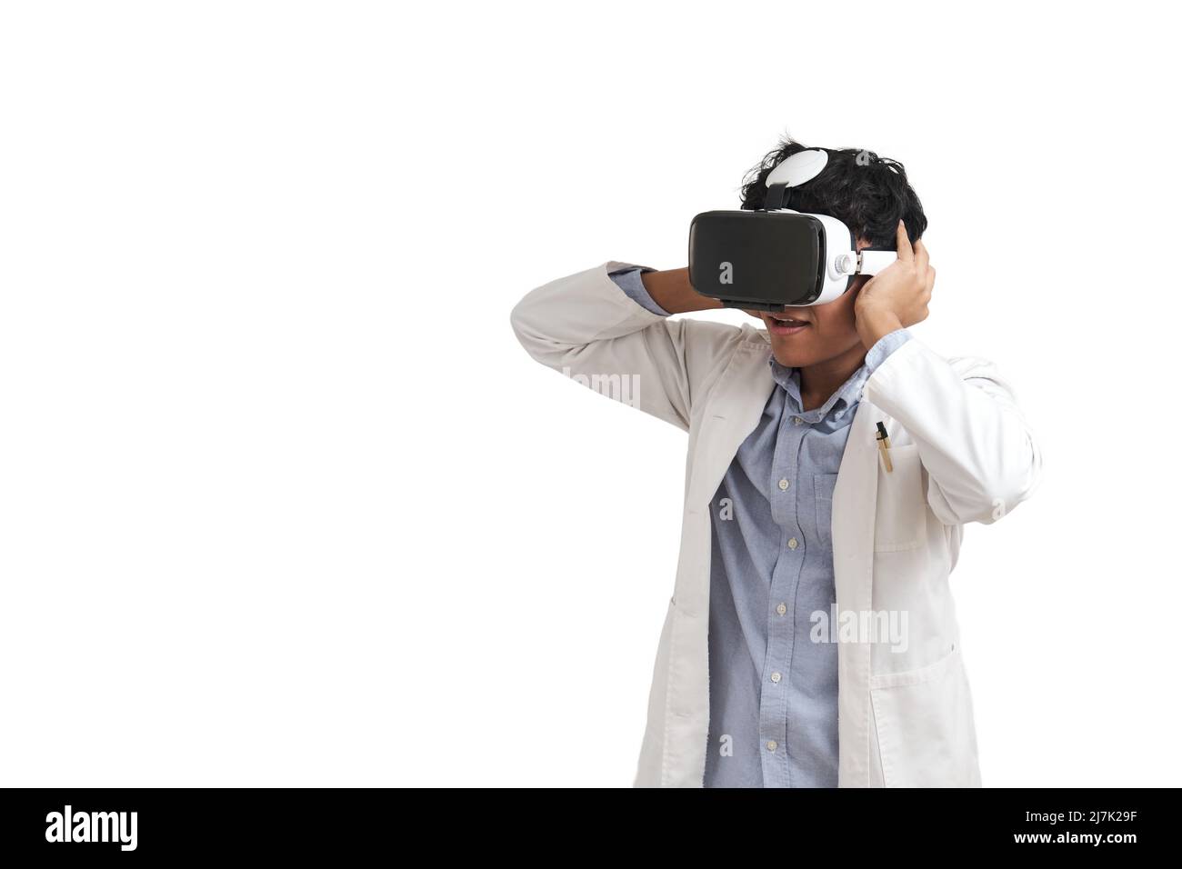 Young peruvian male scientific using virtual reality headset, isolated. Stock Photo