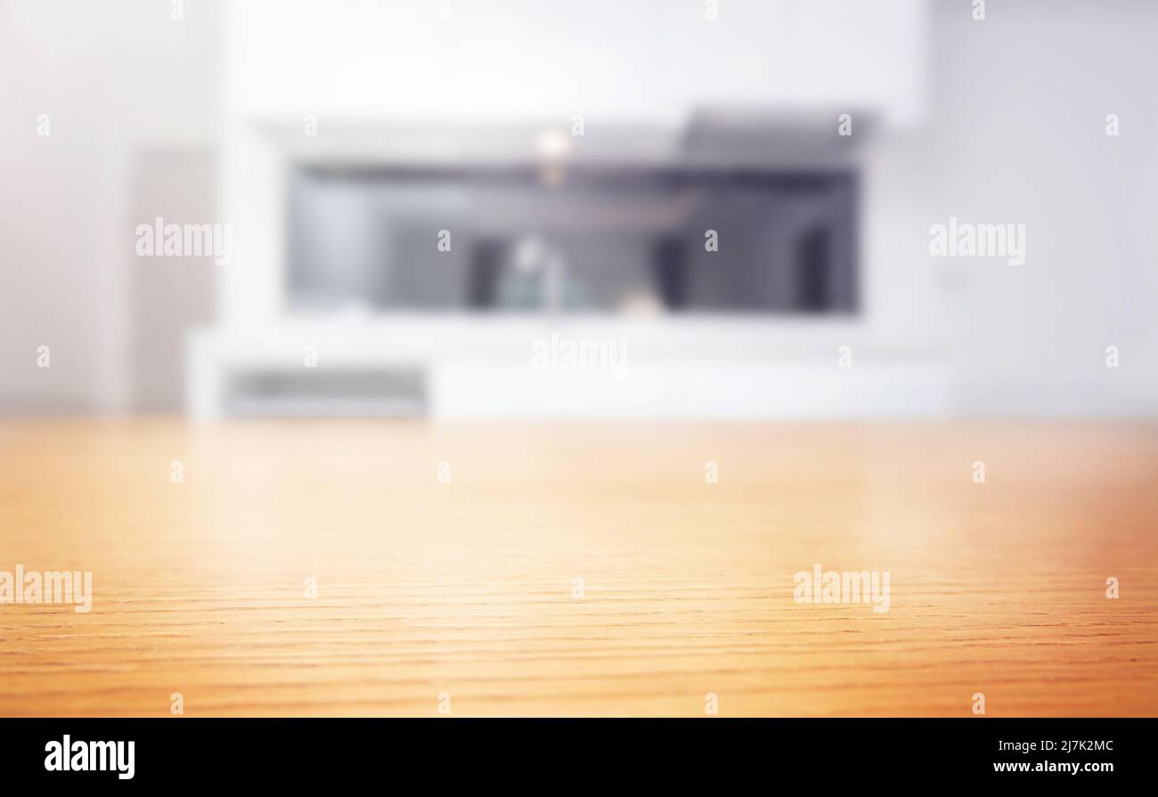 Wooden table top with blurred kitchen on background Stock Photo