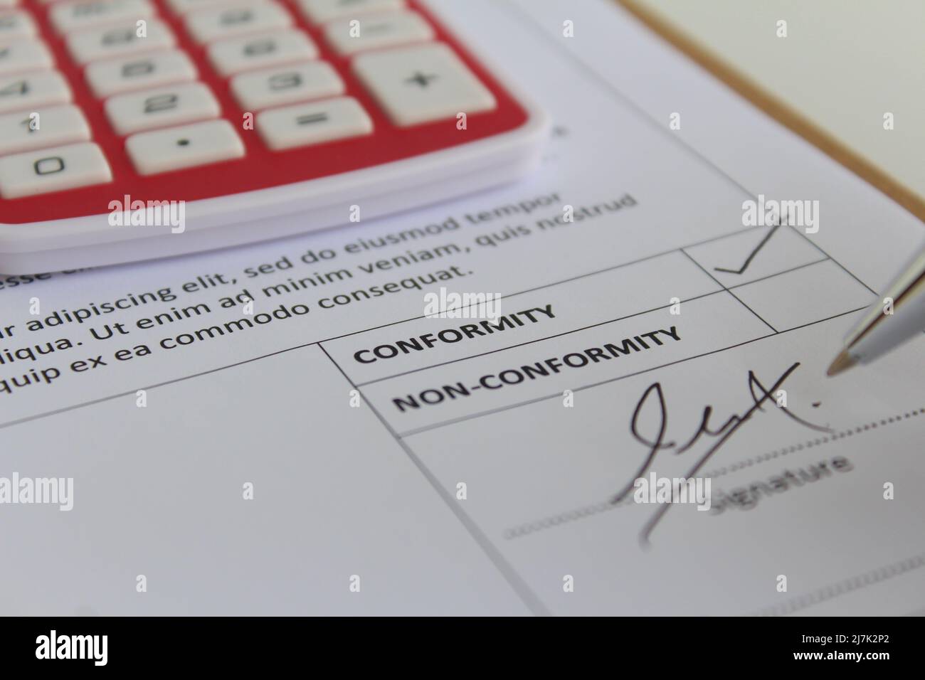 An auditor giving signature at audit report and checked it with the