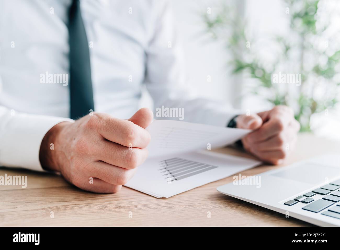 Businessman analyzing business results report in office, selective focus Stock Photo