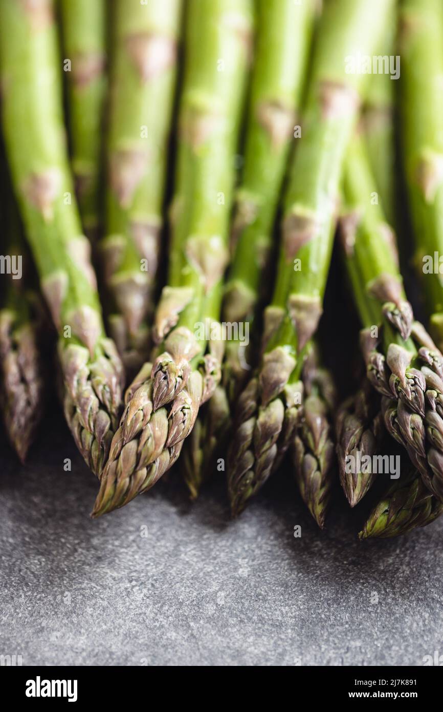 Fresh asparagus on gray table, close up. Stock Photo