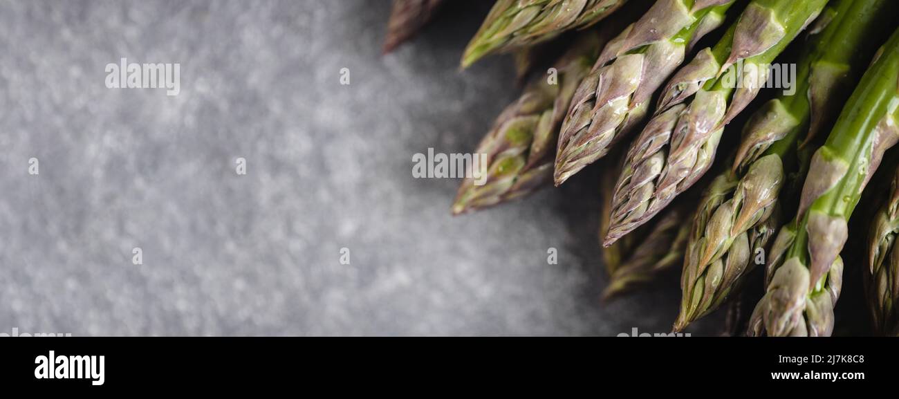 Banner with fresh asparagus on gray table. Stock Photo