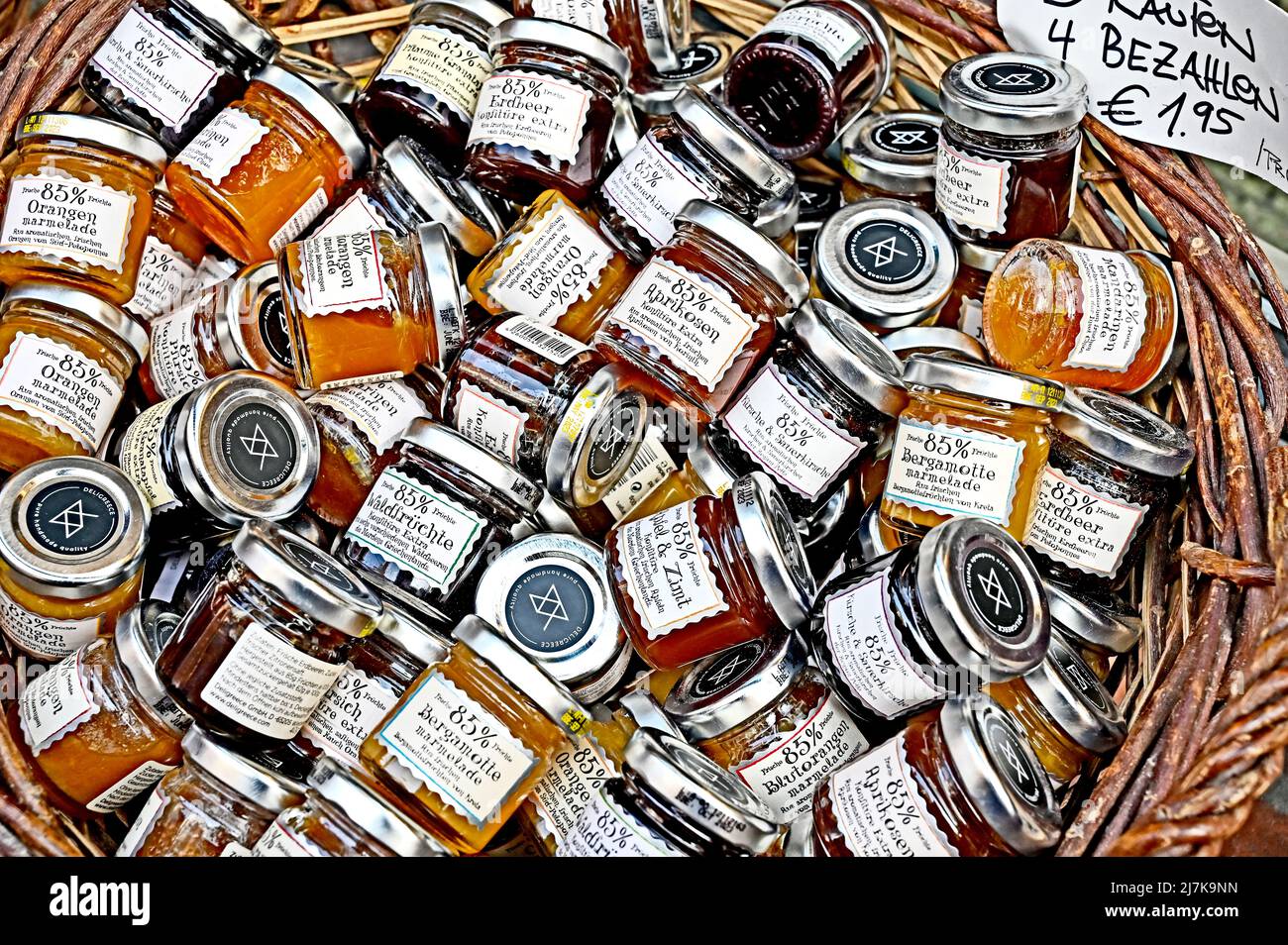 Little glasses of jam or marmelade on display; Mini Gläser mit Marmelade im Korb als Angebot Stock Photo