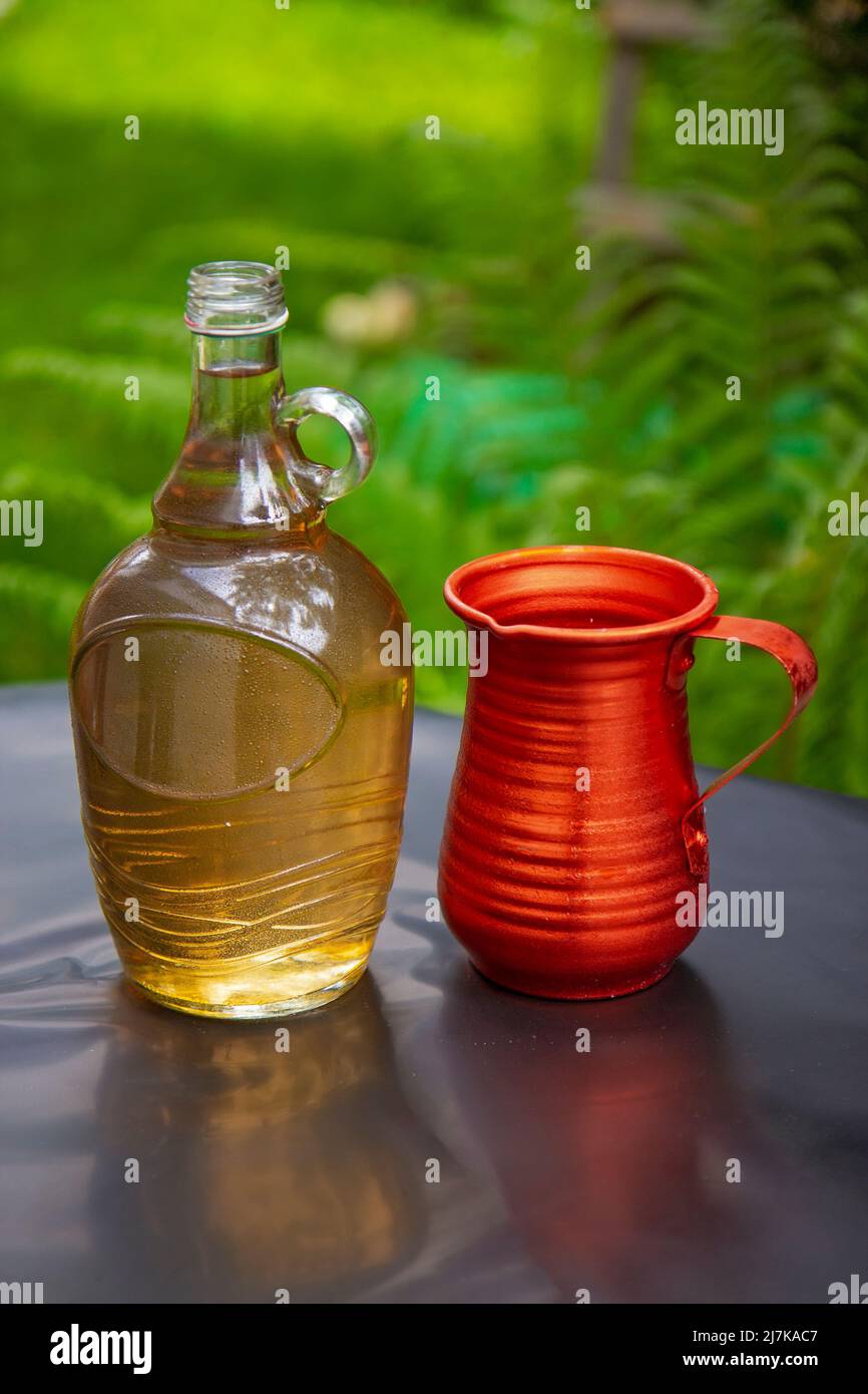 Bottle of white wine and metal jug on the table Stock Photo