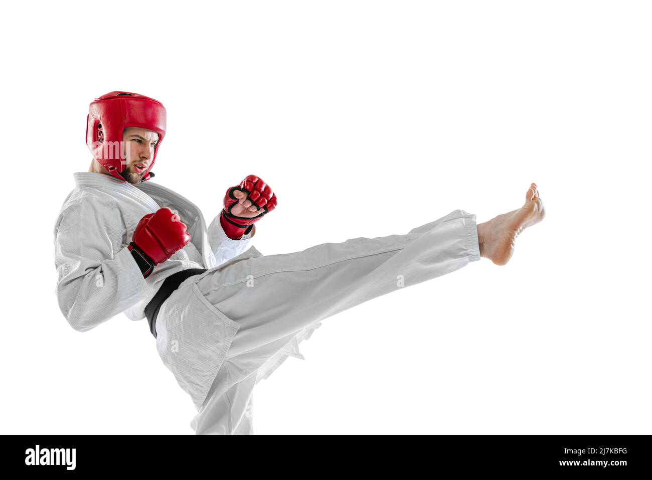 Portrait of young sportive man taekwondo fighter wearing white dobok helmet and gloves practicing isolated over white background. Concept of sport Stock Photo Alamy