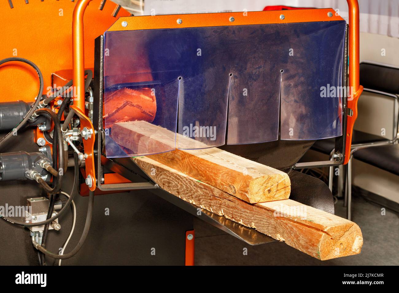 Powerful industrial electric wood chipper with wood logs, used for