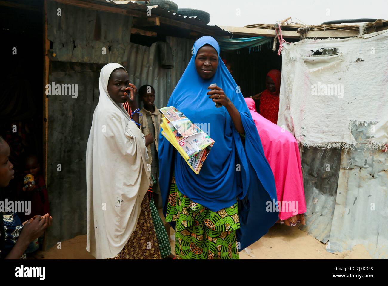 A woman holds a bag and leaflets she received at a safety training workshop for displaced victims of the Boko Haram insurgence about the identification of marked objects of danger, at the Gubio camp in Maiduguri, Nigeria May 6, 2022. Picture taken May 6, 2022.REUTERS/Afolabi Sotunde Stock Photo