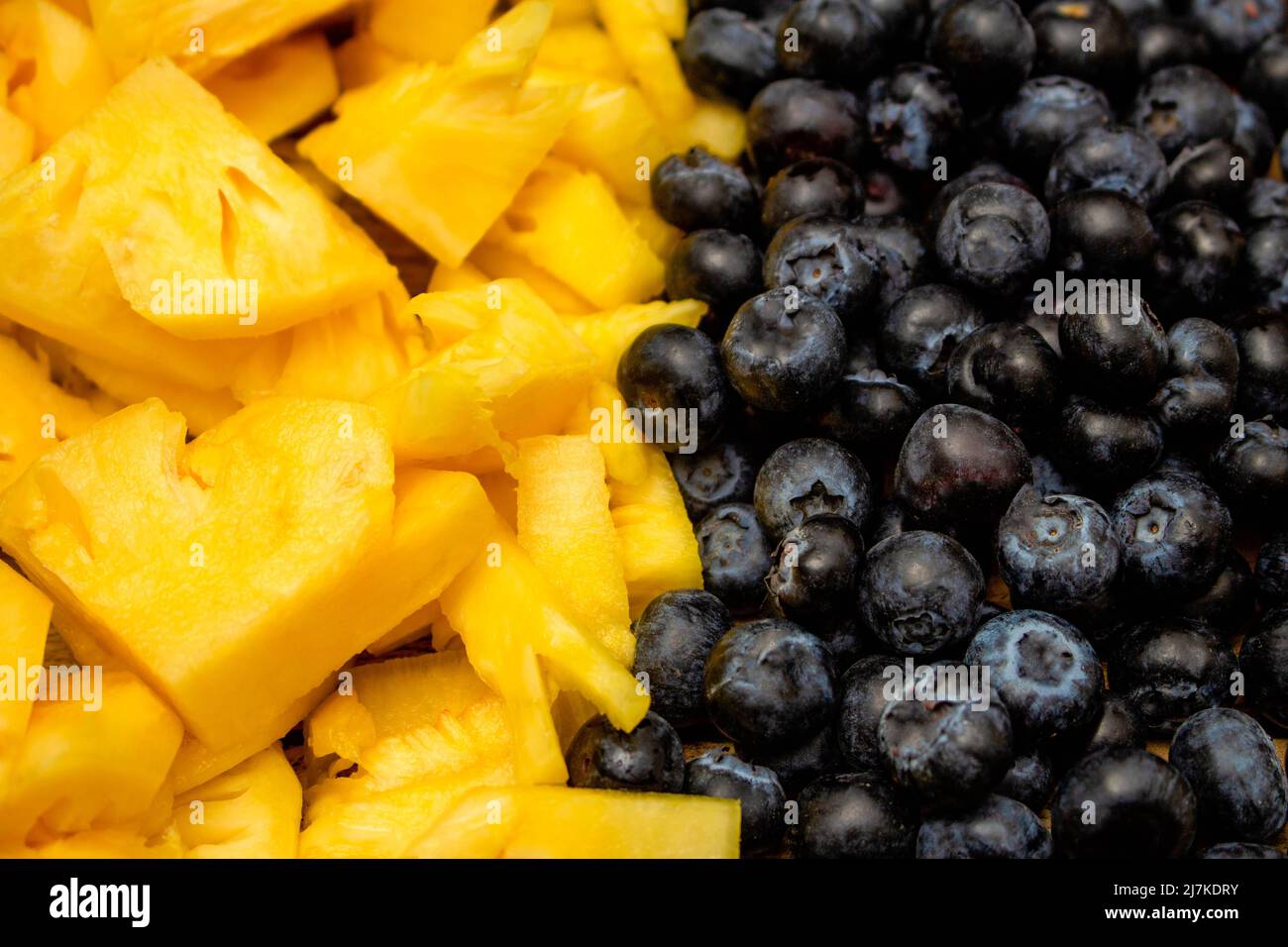 Fresh fruits background, Tropical fruit and berries are consisted of slice  pineapple and blueberry Stock Photo - Alamy