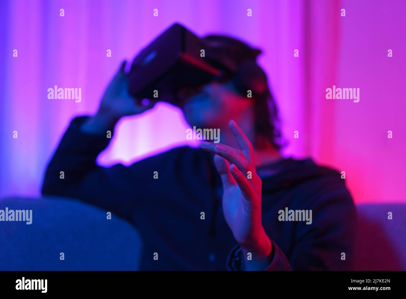 Metaverse technology concept, Man holding VR goggles and pointing to