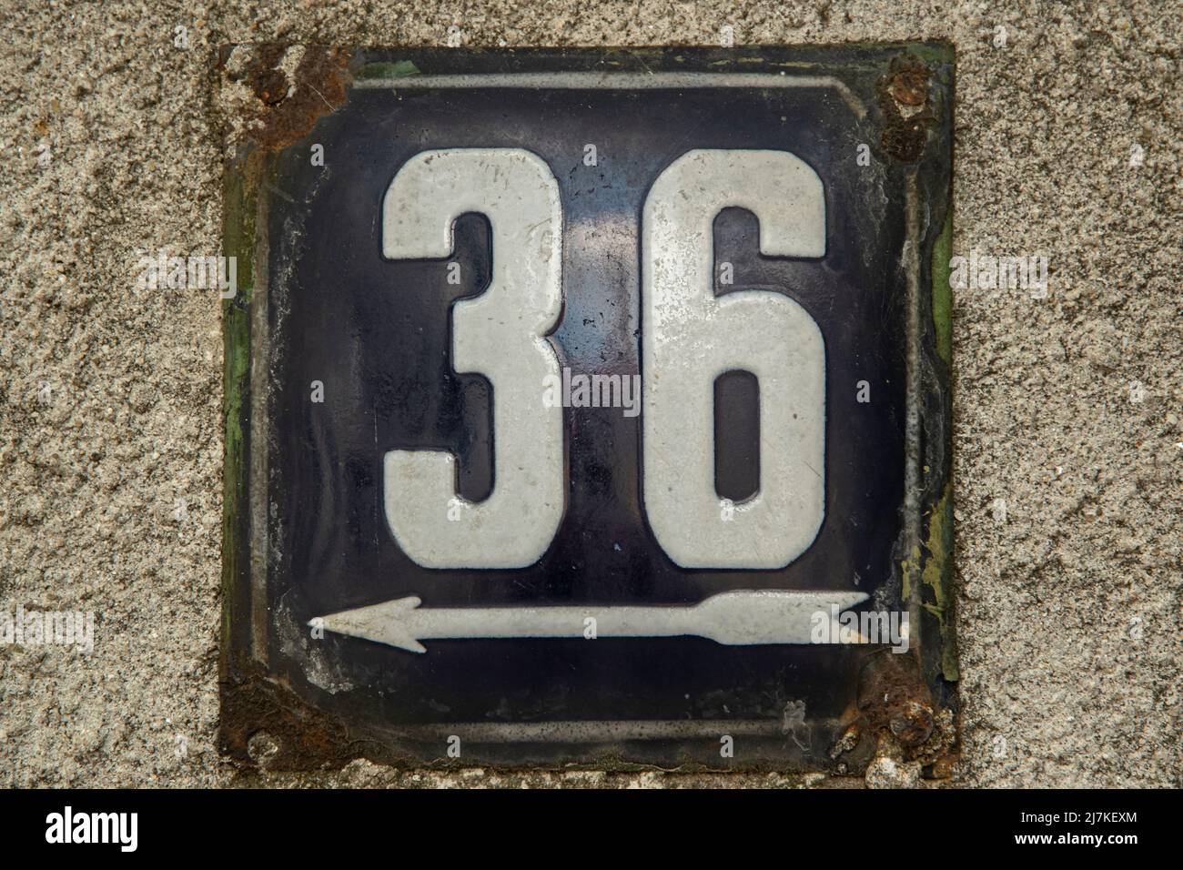 Weathered grunge square metal enamelled plate of number of street address with number 36 Stock Photo