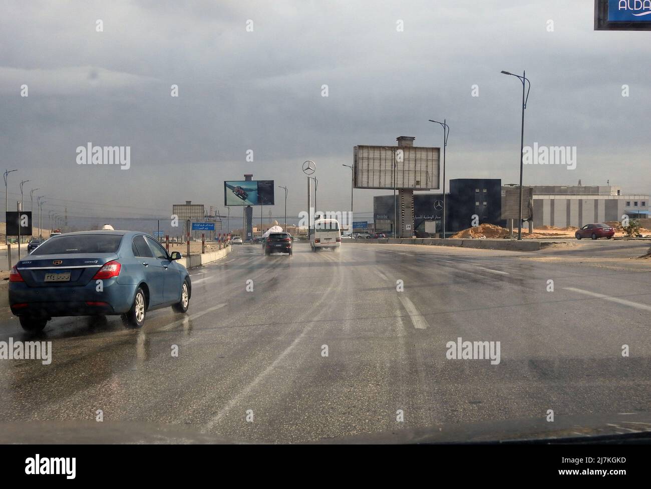 Giza, Egypt, December 30 2021: raining weather, traffic on a cloudy day bad weather condition during rains, road view through car window blurry with h Stock Photo