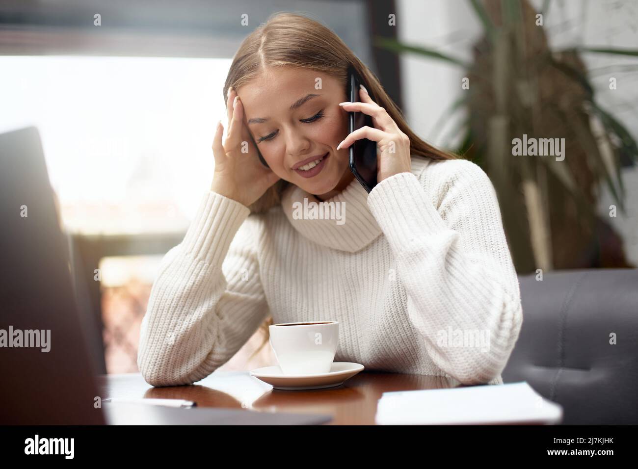 Woman calling, talking and asking about something, using laptop Stock Photo
