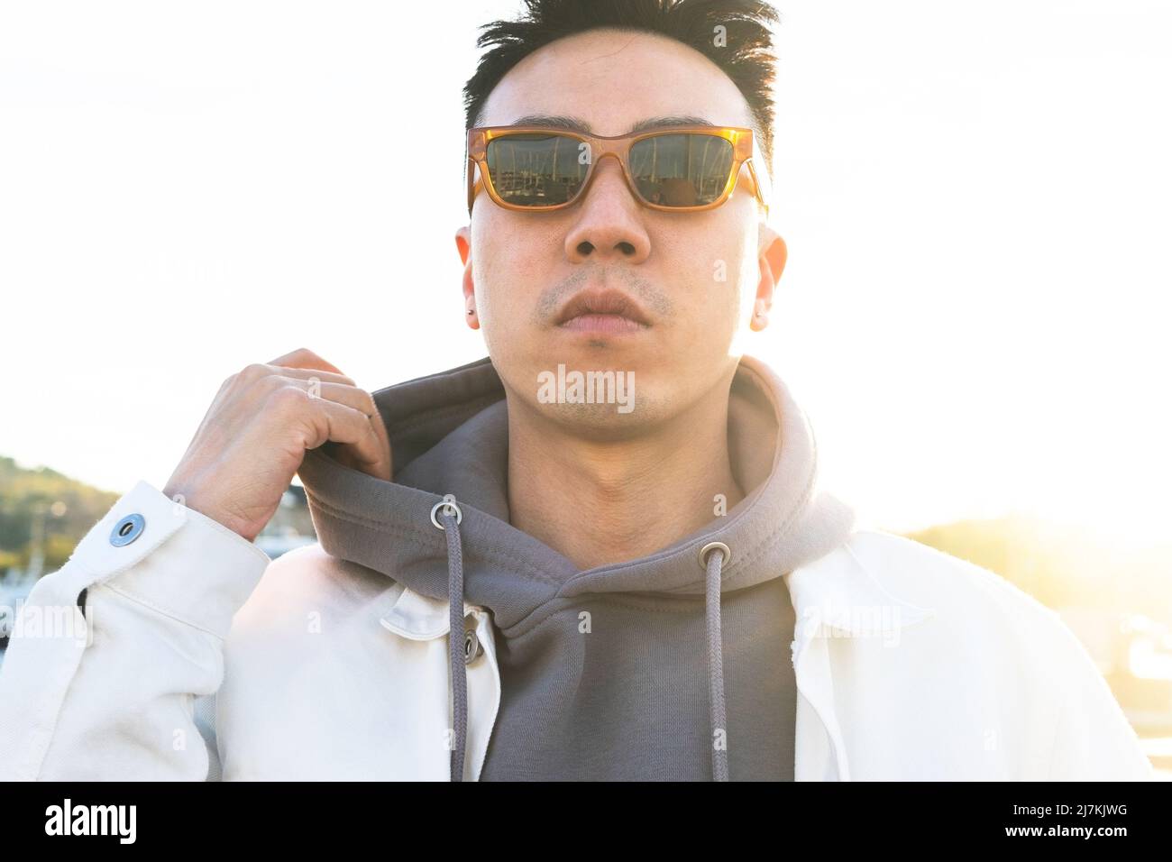Serious man in hood sunglasses hi-res stock photography and images - Alamy