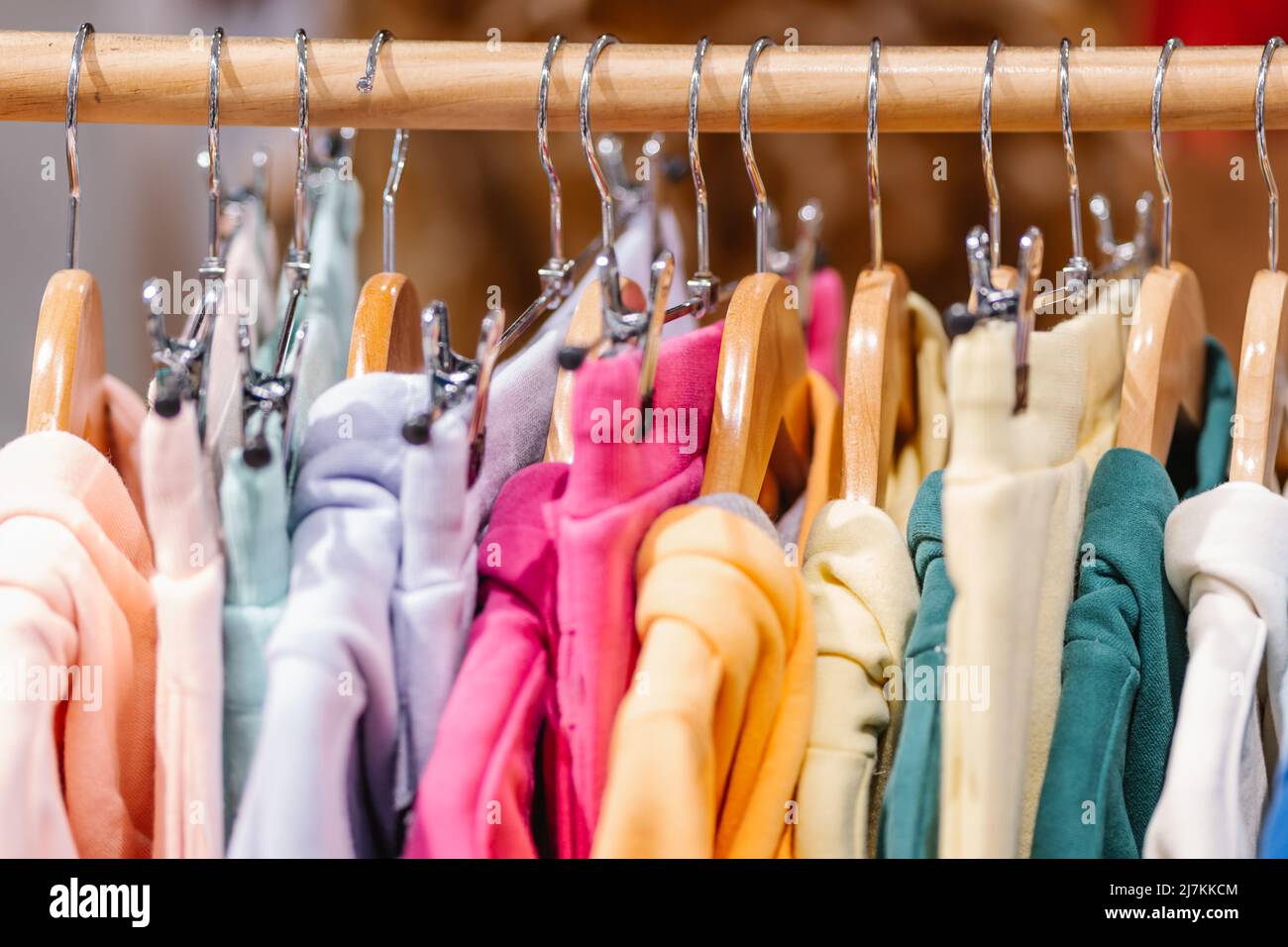 Hoddies On A Rack Soft focus of set of colorful hoodies hanging on rack in modern clothes ...