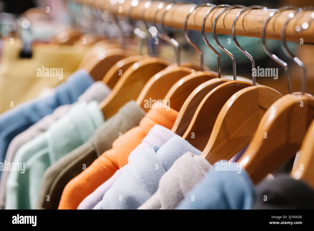 Hoddies On A Rack Soft focus of set of colorful hoodies hanging on rack in modern clothes ...
