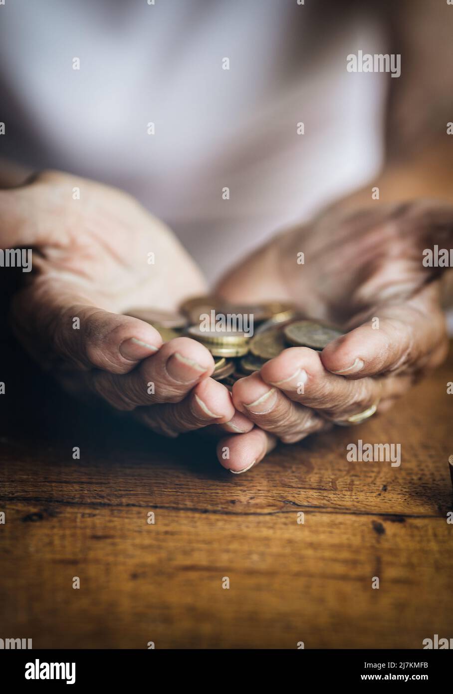 Elderly retired woman and her savings in a jar Stock Photo
