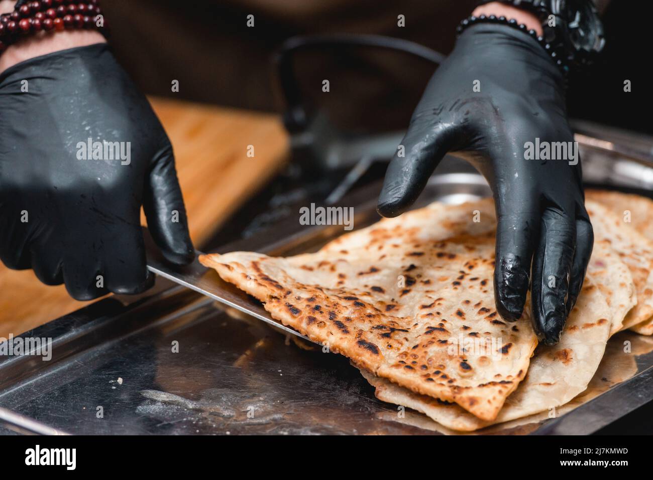 Chief serving cheburek traditional balkan meat pastry pie with herbs