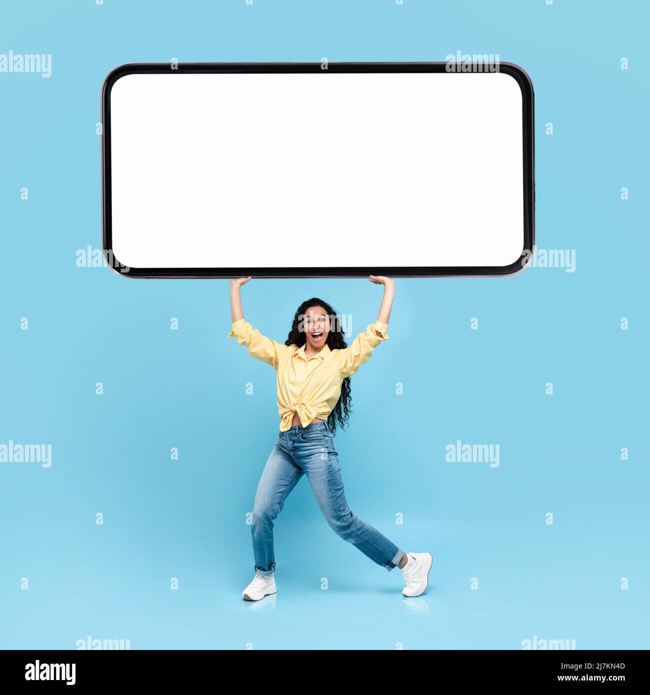 Excited lady holding heavy white empty smartphone screen Stock Photo