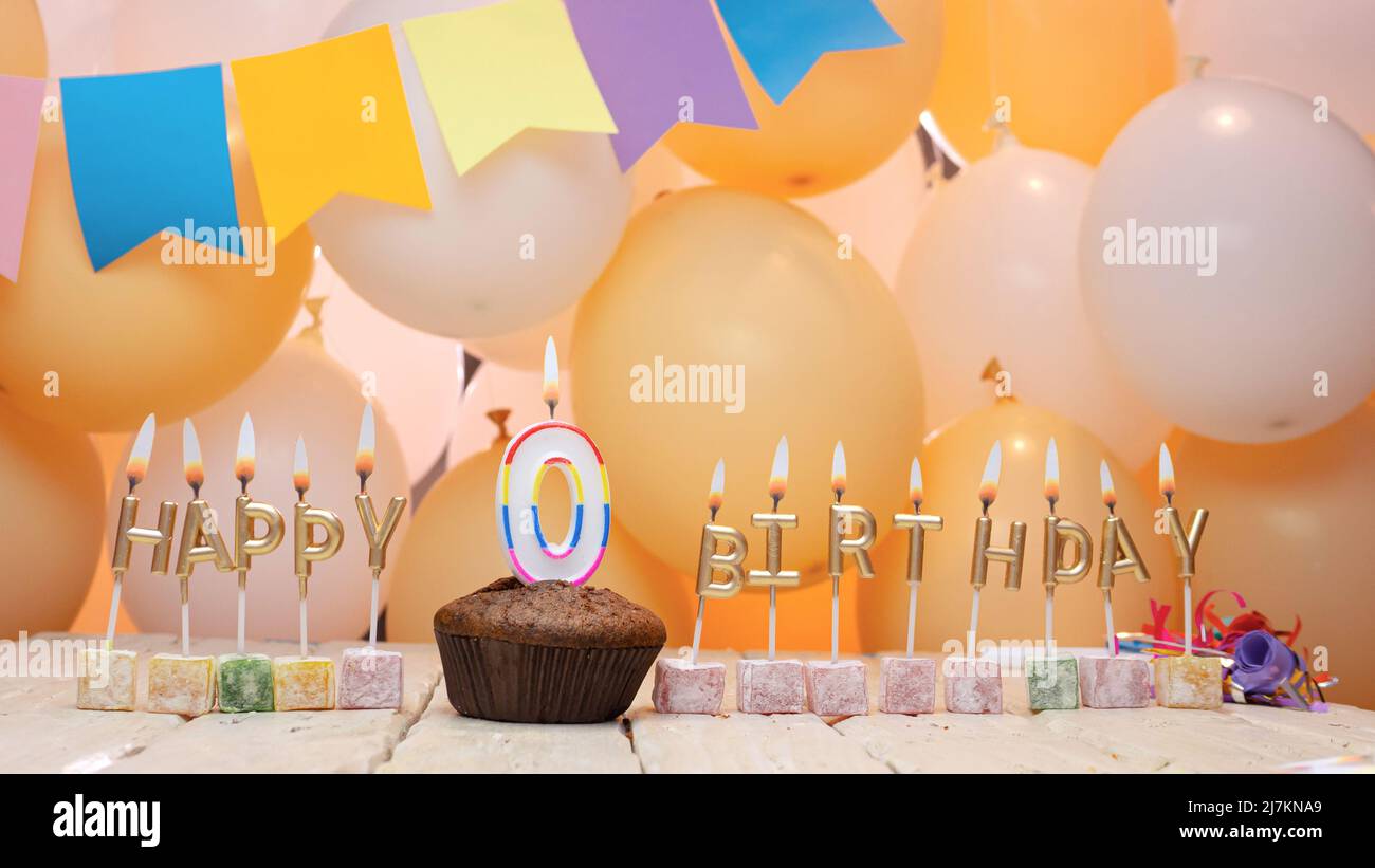 Happy birthday to a child from golden letters of burning candles on the