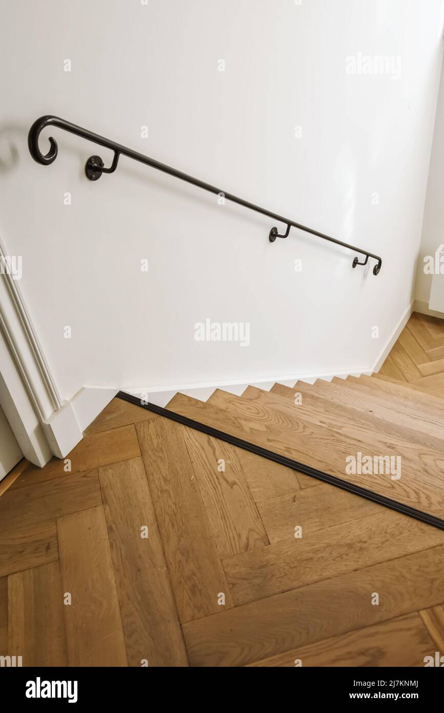 From above of wooden stairway and metal railing in corridor of classic ...