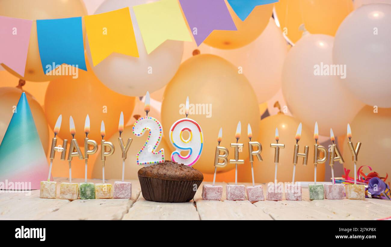 Happy birthday to a child from golden letters of burning candles on the background of my balloons. Beautiful birthday card Stock Photo