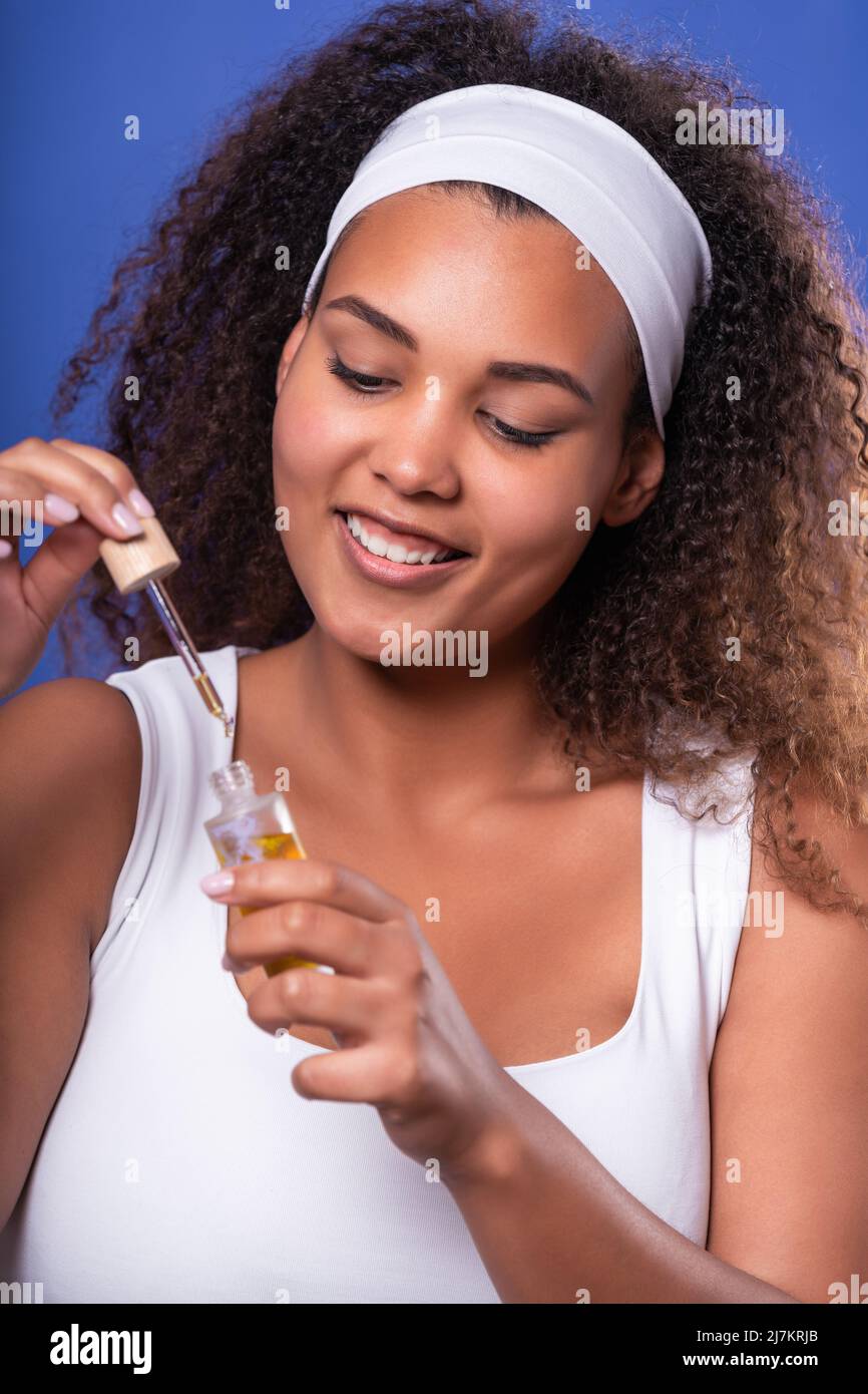 smiling young Hispanic female model with perfect skin and long