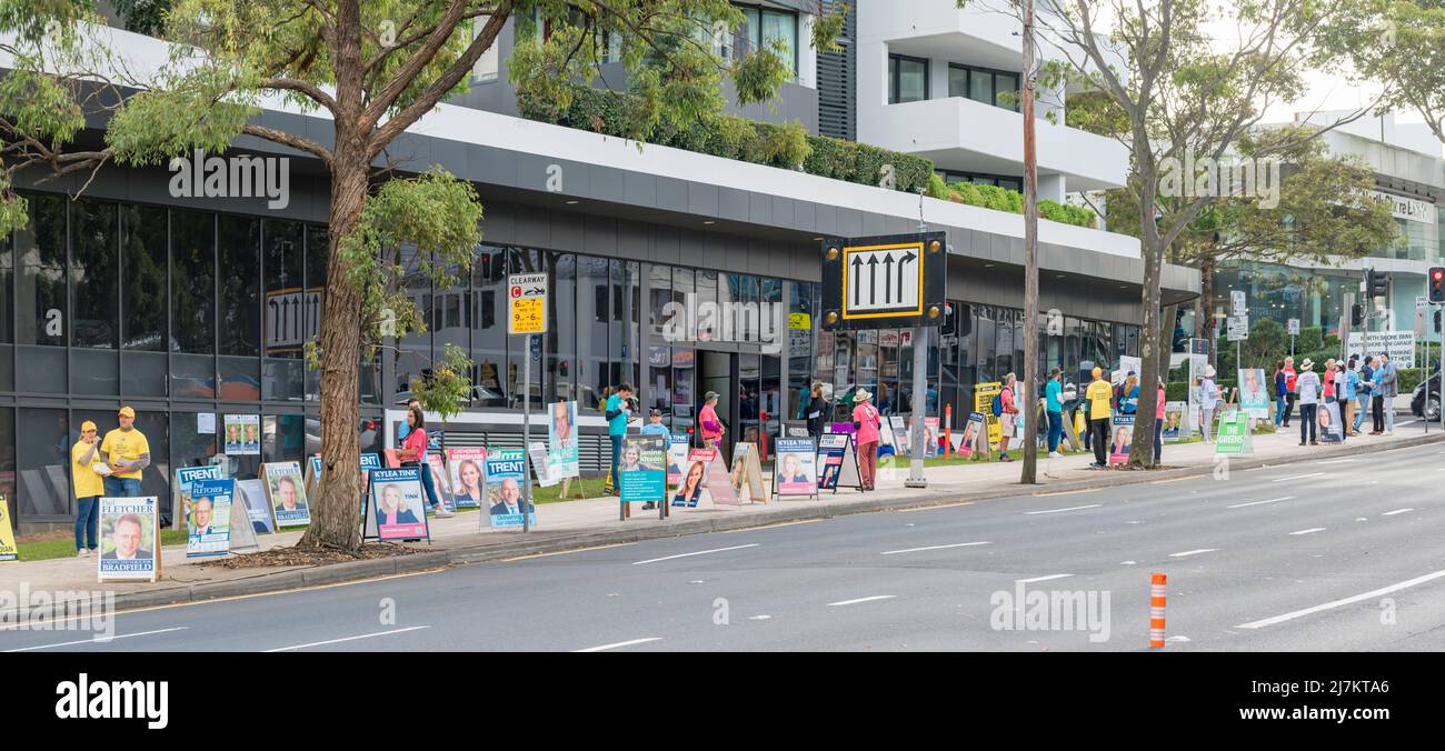 Chatswood, Sydney, Australia May 10th, 2022: Volunteers stand beside sandwich board posters of candidates and wait to hand out how to vote pamphlets to people attending the pre-polling station in Chatswood on Sydney's north shore in New South Wales, Australia. Voting in Australia is compulsory and certain categories of voters qualify to vote within two weeks of the coming election on May 21st Stock Photo