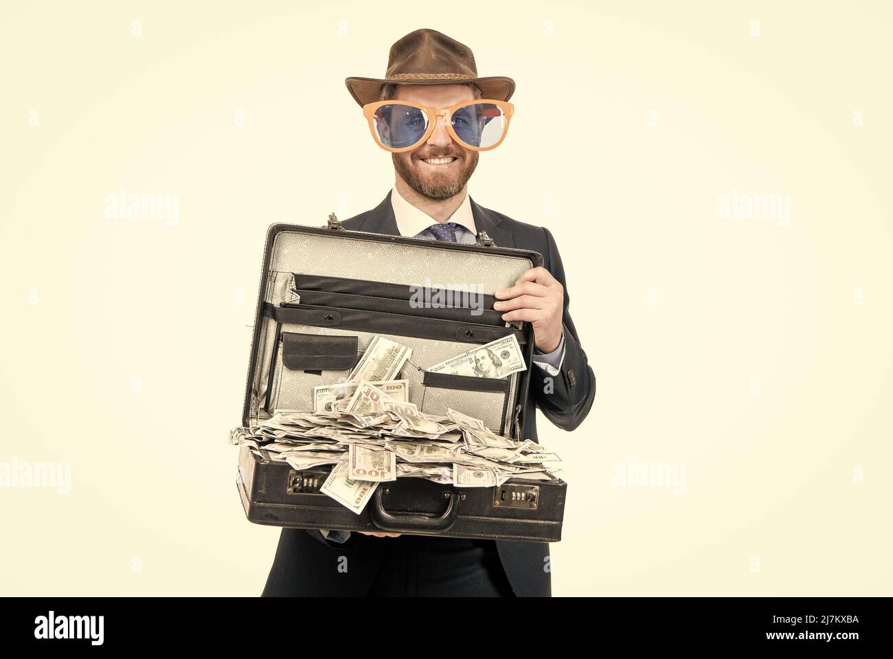 Get a million dollars. Rich man. Businessman hold suitcase with cash