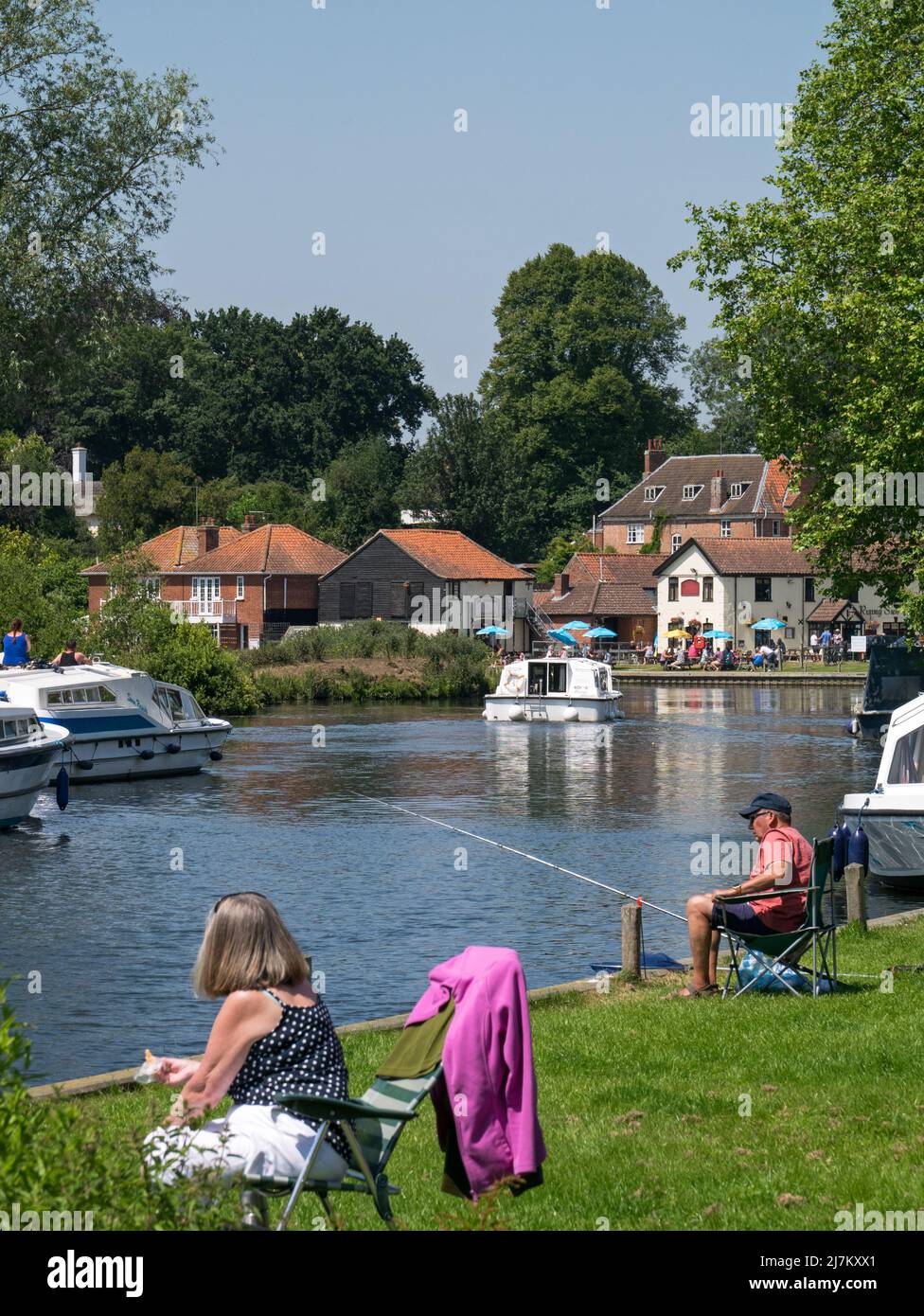 The River Bure on The Norfolk Broads at Coltishall, popular for picnicking & fishing, as well as boating, Coltishall, Norfolk, England, UK, Stock Photo