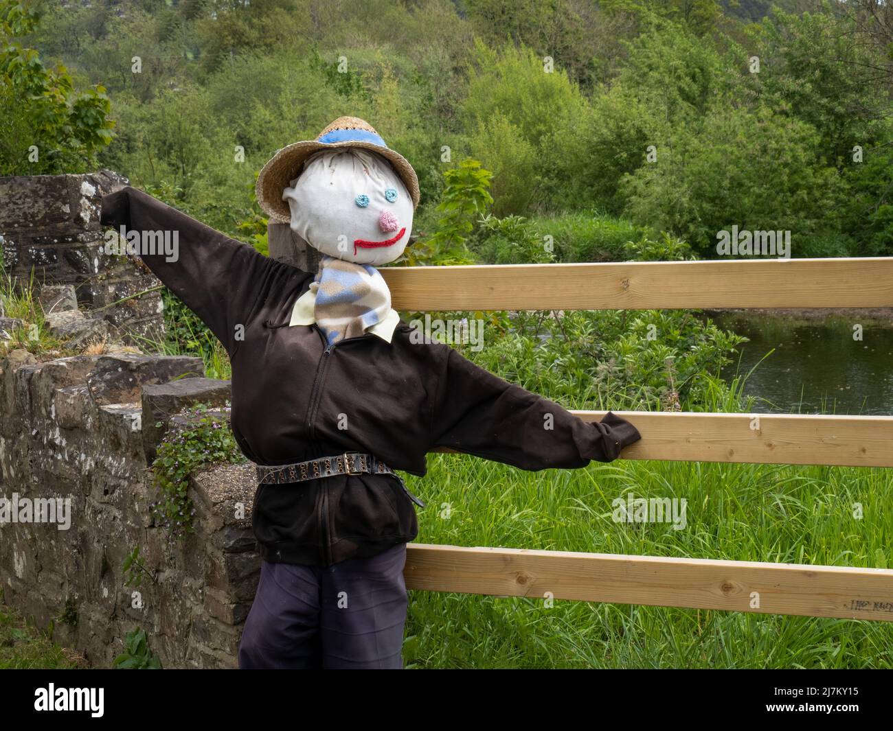 Scarecrow by gate in rural setting. Stock Photo