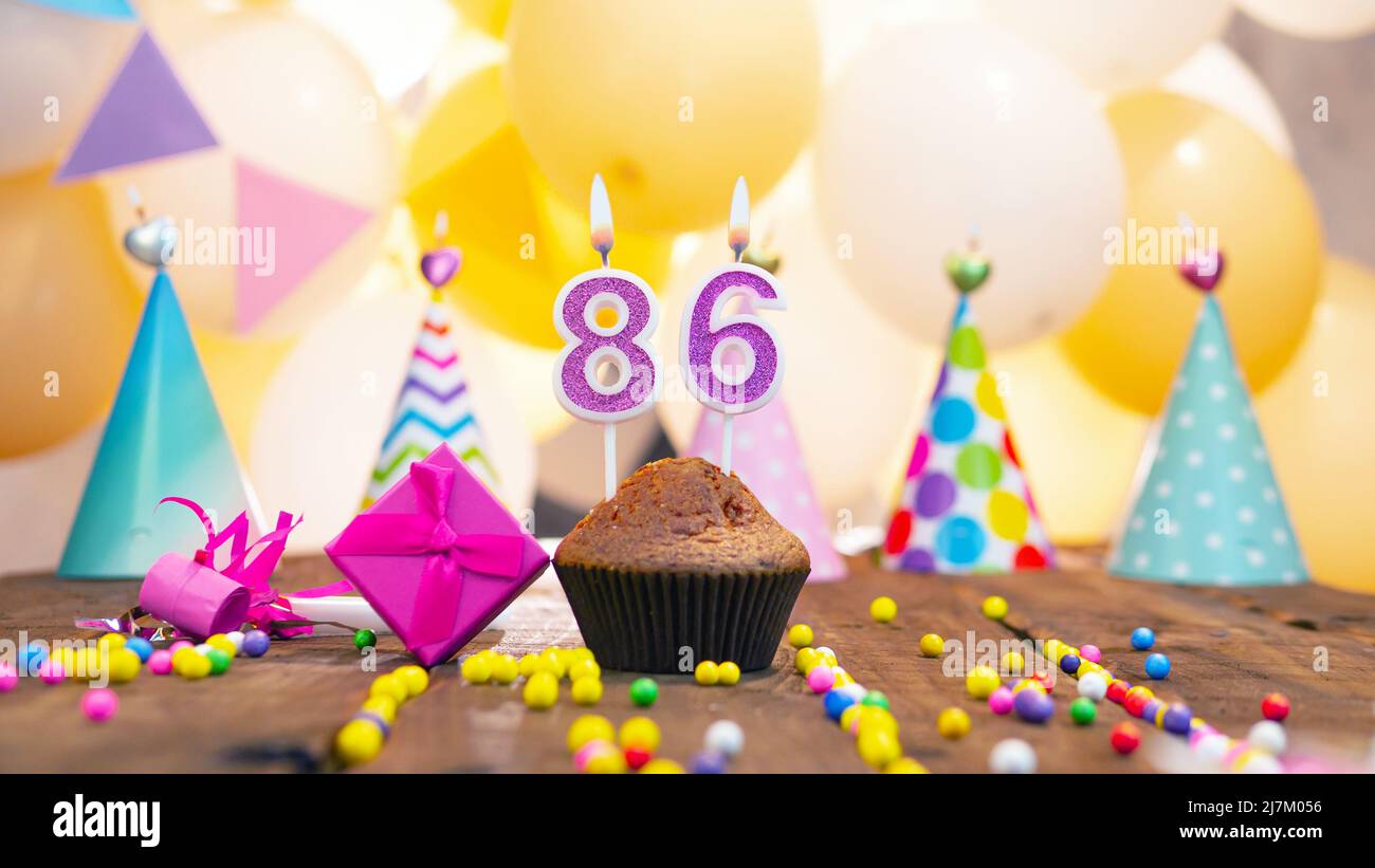 Happy birthday with candles on a background of balloons. A festive