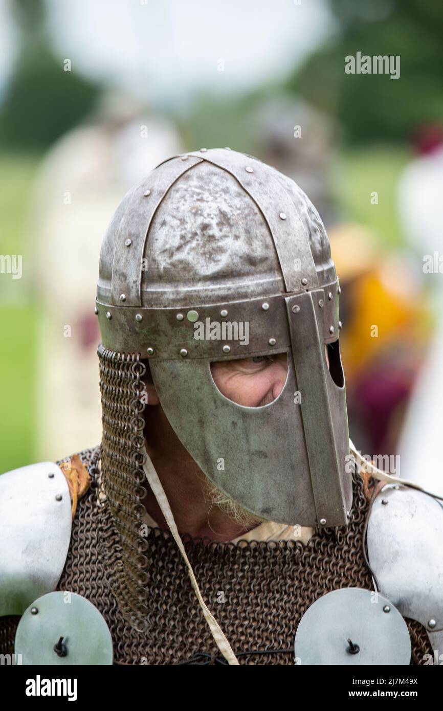 Medieval battle re-enactment with men wearing a cervelliere or skull cap  helmet and chain mail aventail or camail to protect the neck Stock Photo -  Alamy
