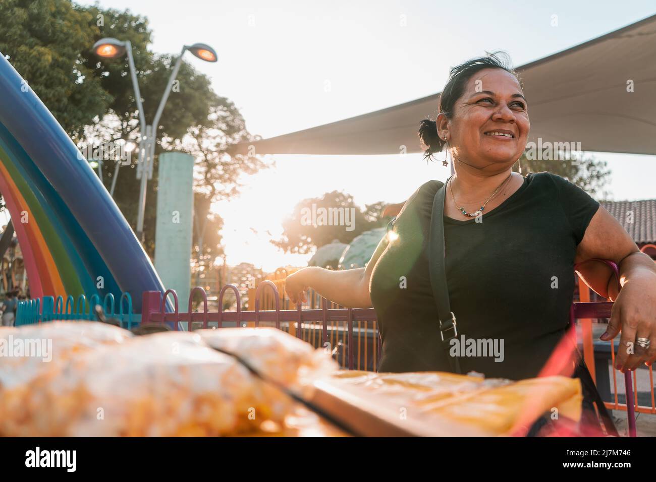 Itinerant fruit vendor in a park in Managua Nicaragua smiling at sunset. Concept of self-employment Stock Photo