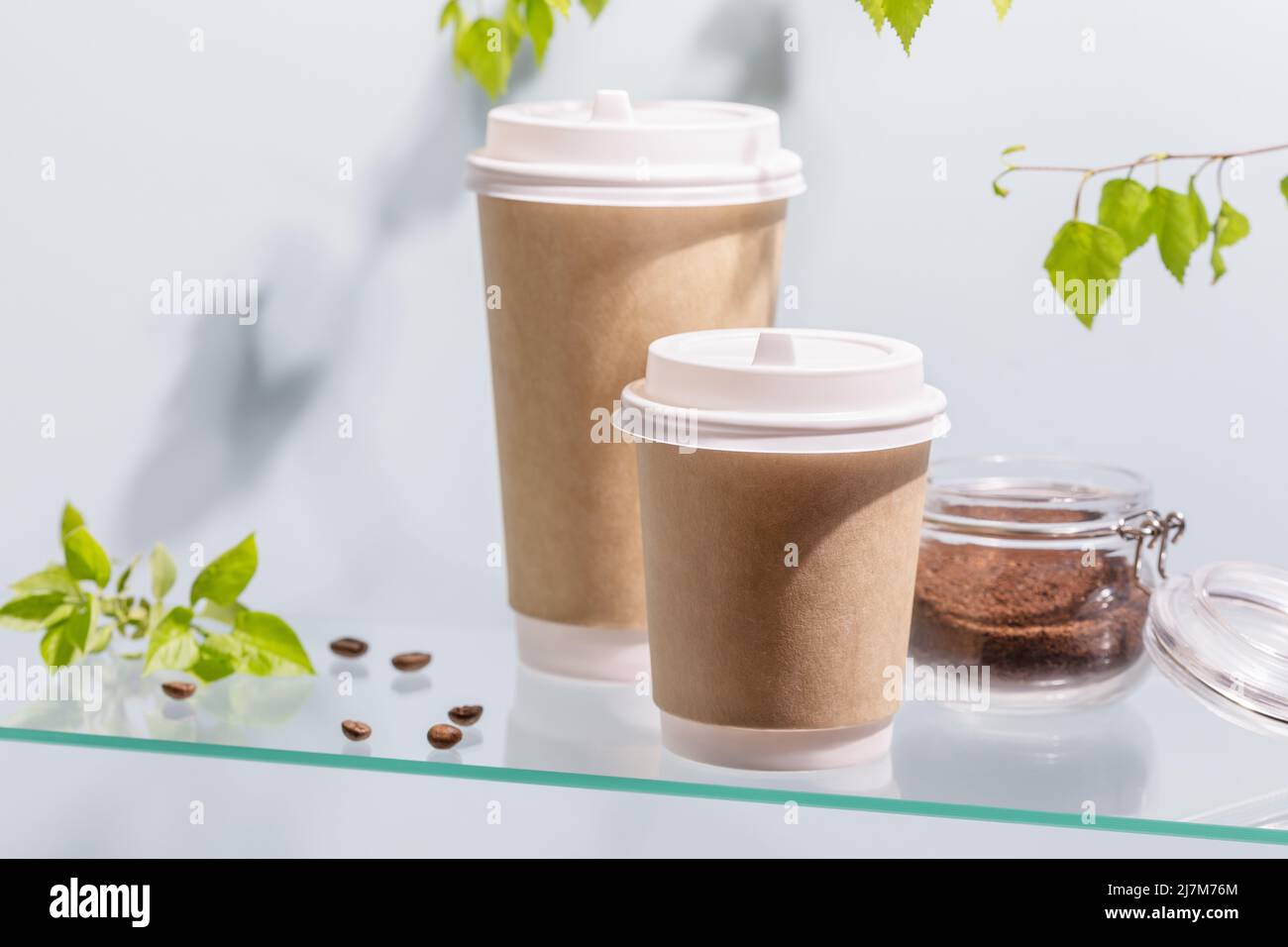 Coffee to go. Two disposable ecofriendly cardboard cups, ground coffee