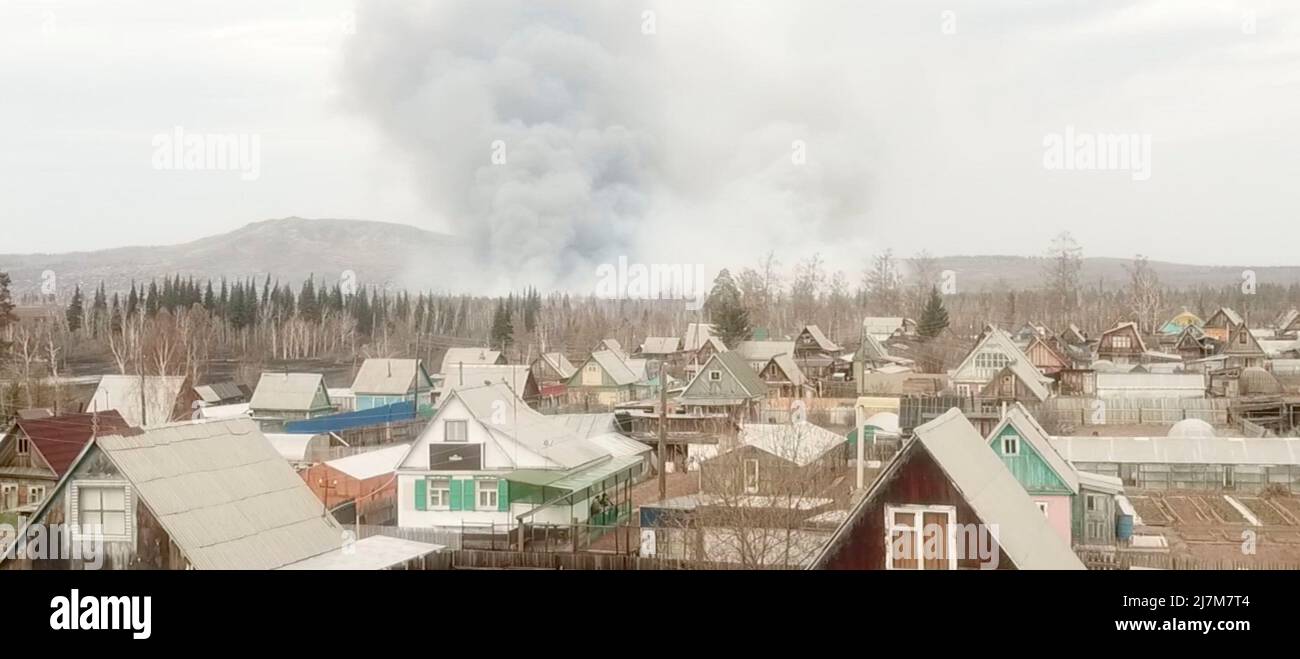 Smoke from a wildfire rises above the village of Morgudon in the Irkutsk Region, Russia, in this still image taken from a video. Video taken May 7, 2022. REUTERS TV via REUTERS Stock Photo