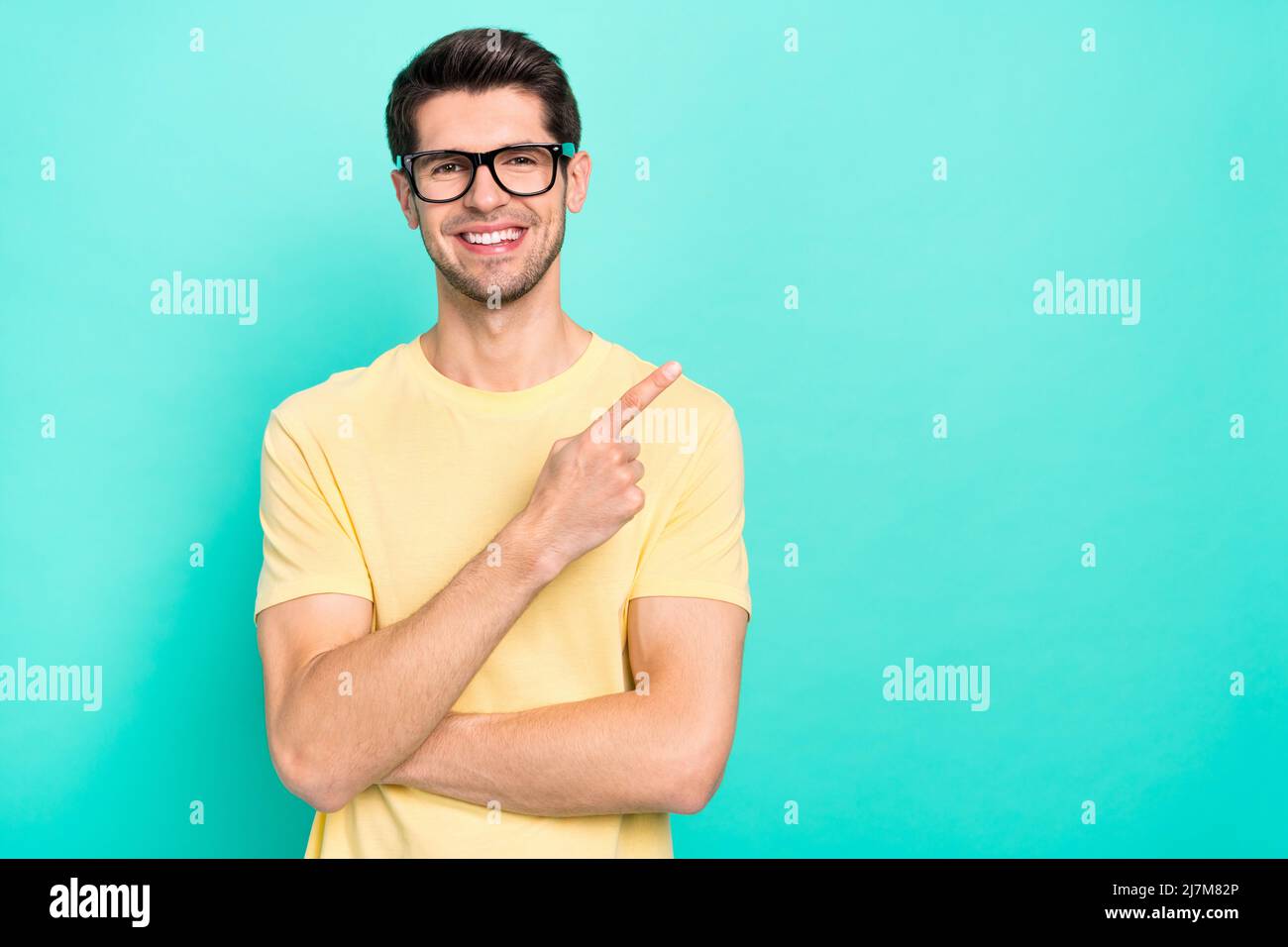 Photo of funny young guy index promo wear eyewear yellow tshirt
