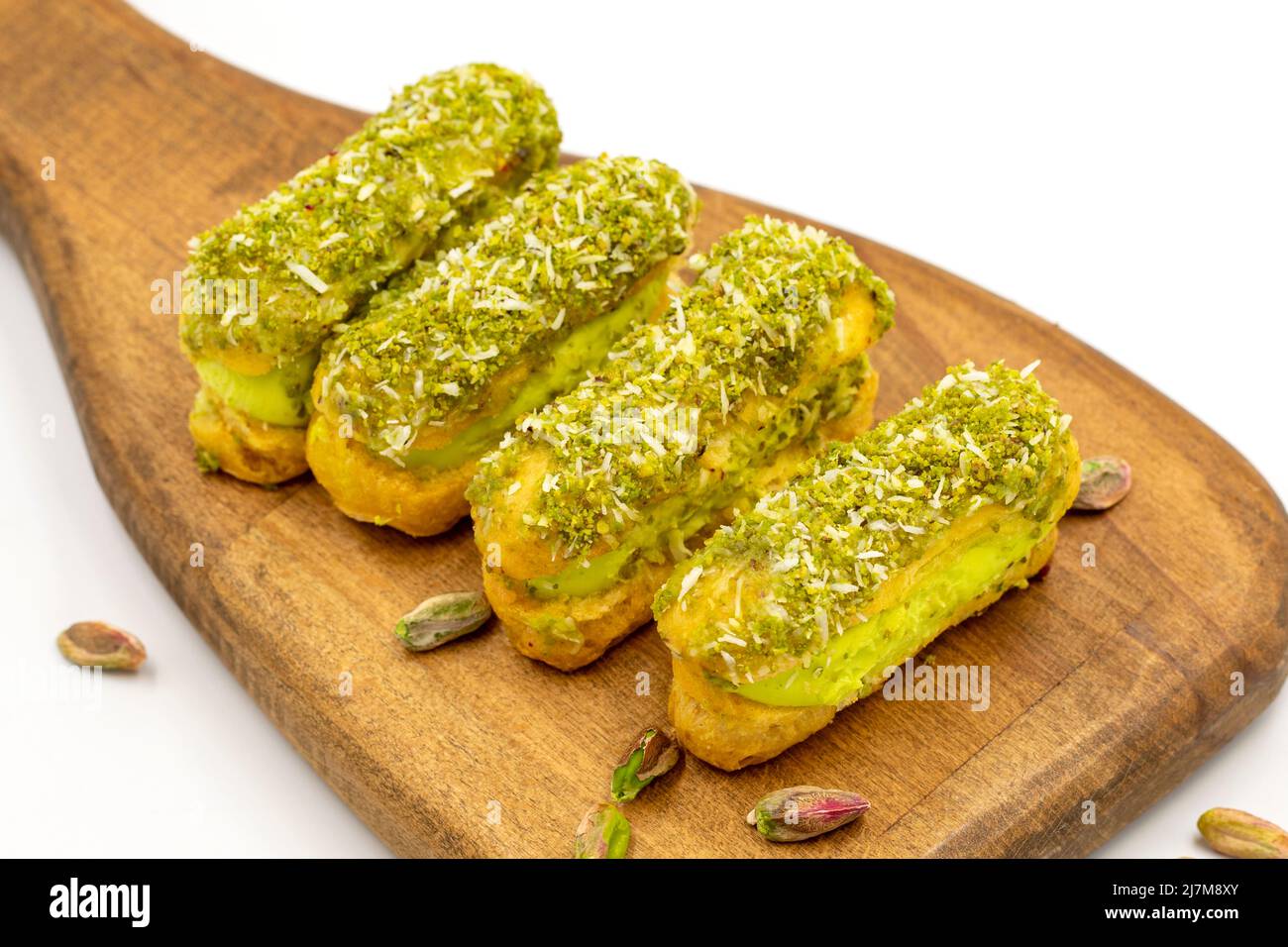 Pistachio eclair cake. Eclair cake with pistachio filling on a white