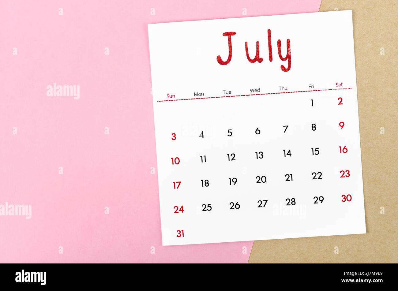 The July 2022 calendar on pink background with empty space. Stock Photo
