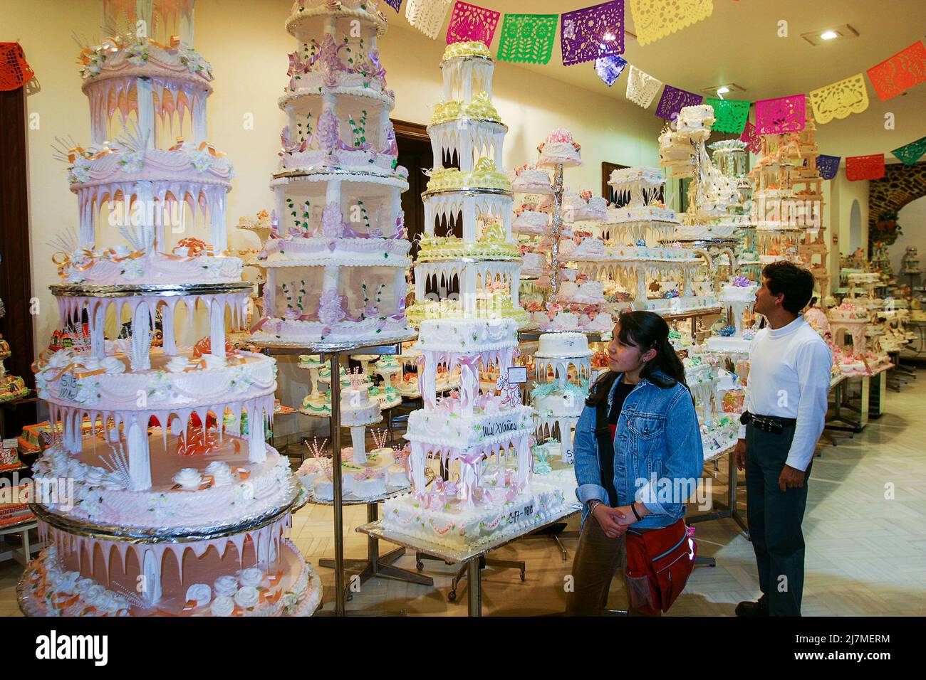 Mexico - Locals looking at fancy cakes, specially made for the 15th birthday at  a local bakery in mexico city Stock Photo