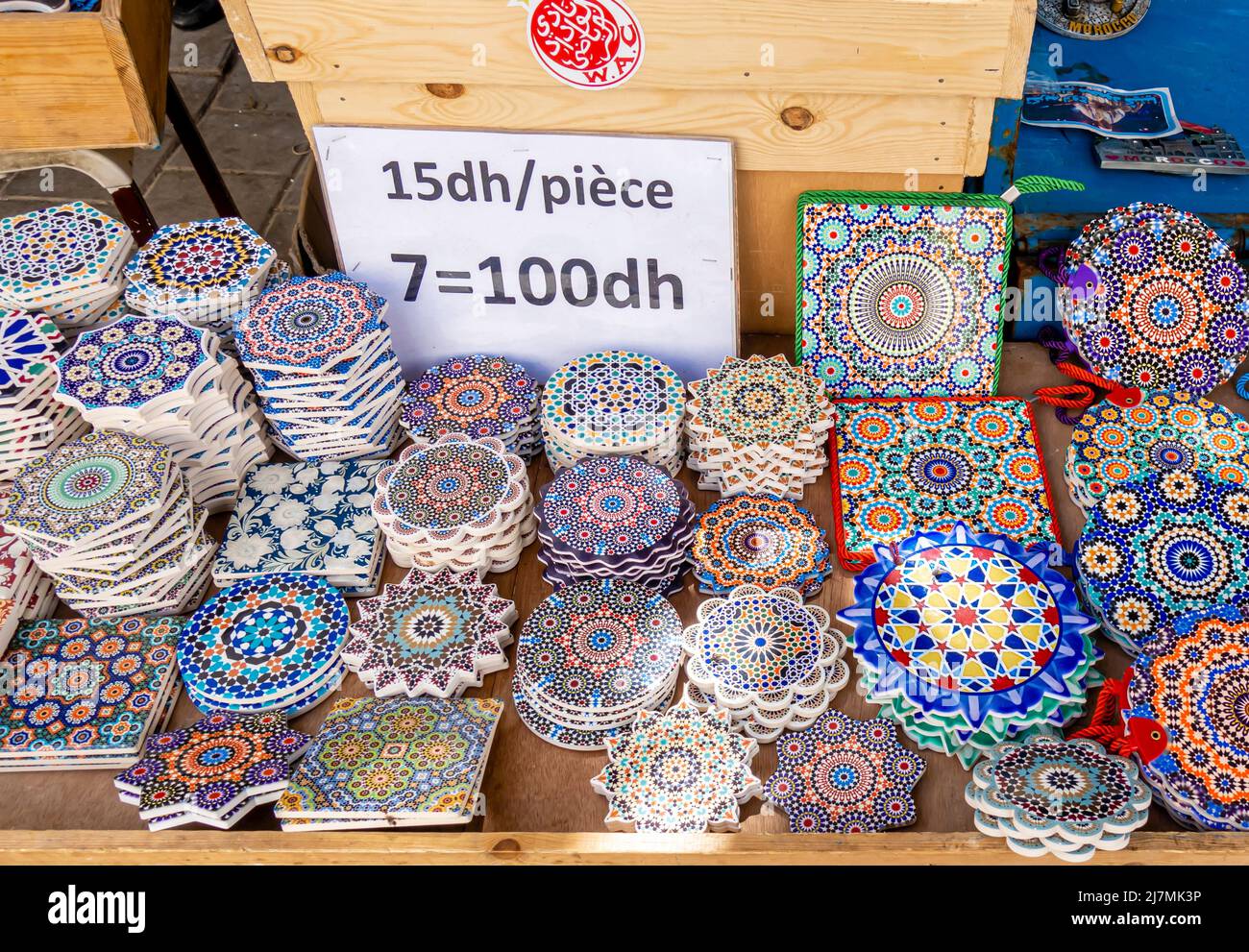 Colorful colourful pottery tiles ceramics with price tag sold o nthe market in Essaouira, Morocco. Traditional Maroccan ornamental decorated plates. Stock Photo