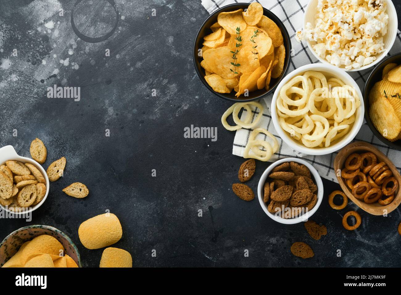 Unhealthy food. Snacks. All classic potato snacks with peanuts, popcorn