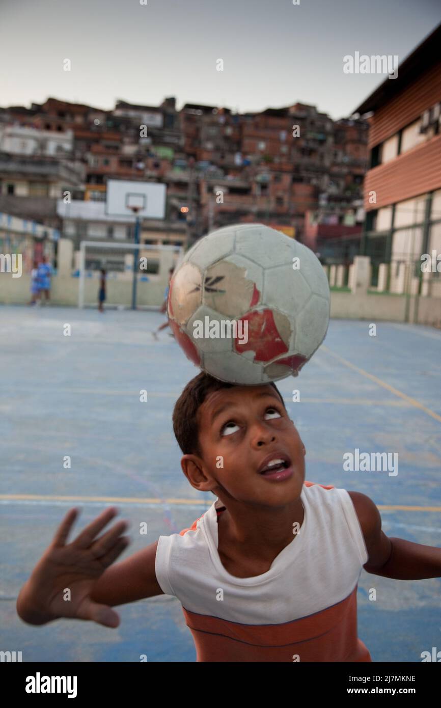 Brazil, Rio de Janeiro, children on a soccer field in one of the many ...