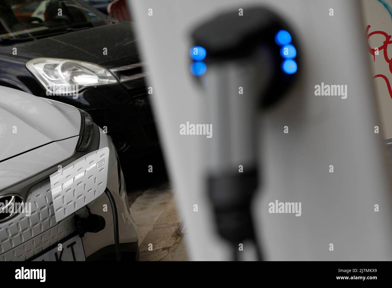 Palma, Spain. 09th May, 2022. An electric car is connected to a charging station in downtown