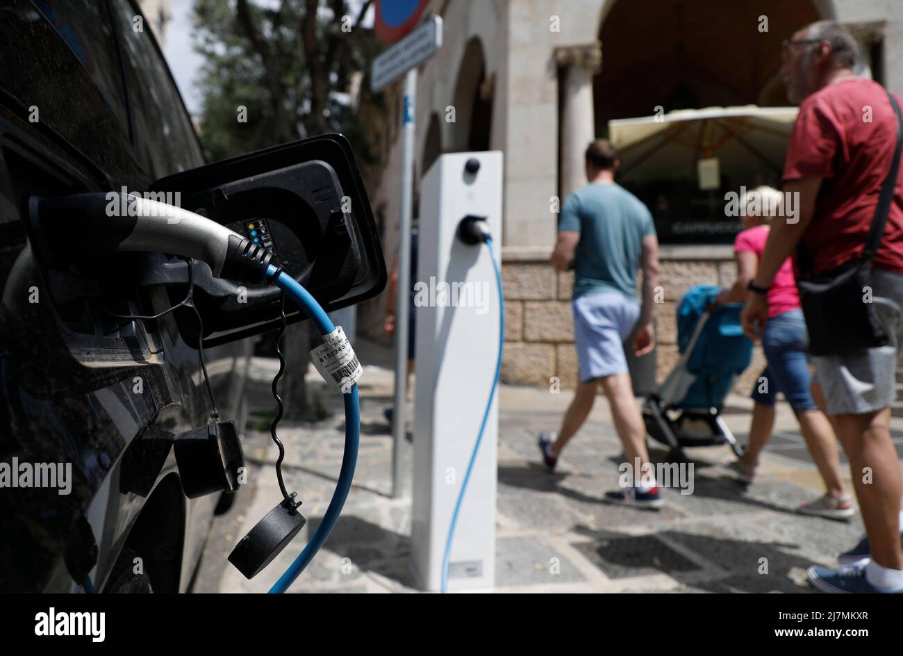 Palma, Spain. 09th May, 2022. An electric car is connected to a charging station in downtown