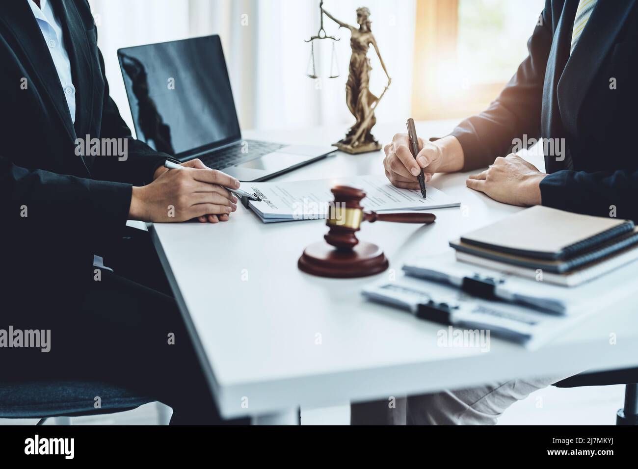 Law, Consultation, Agreement, Contract, Attorney or Lawyer holding a pen is consulting with a client to explain the pattern of answering questions Stock Photo