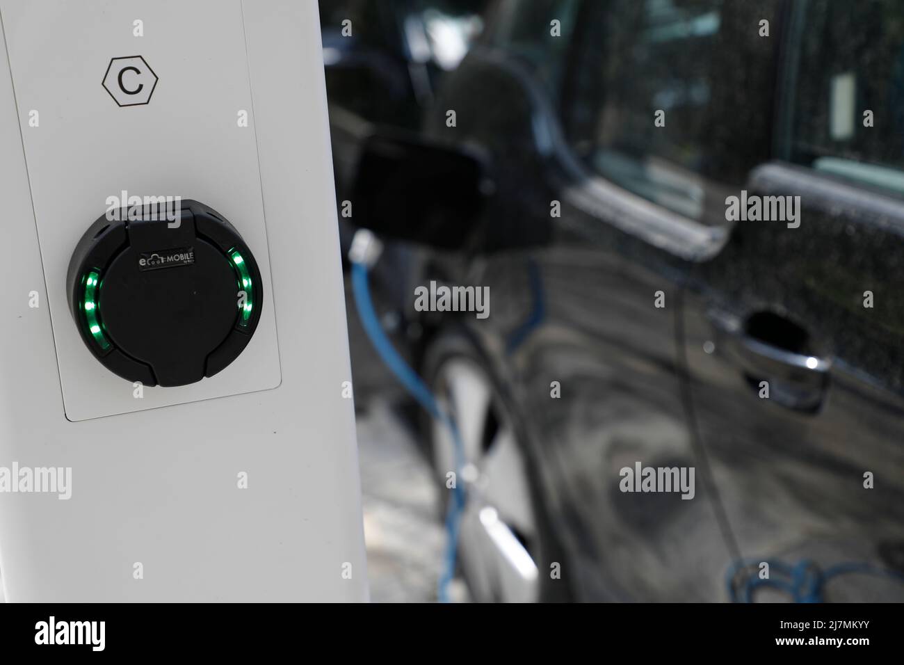 Palma, Spain. 09th May, 2022. An electric car is connected to a charging station in downtown